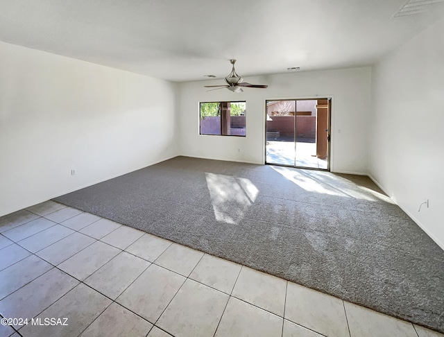 unfurnished room featuring light colored carpet and ceiling fan