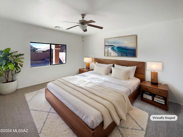 bedroom featuring light colored carpet and ceiling fan