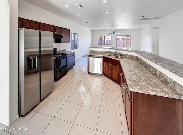 kitchen with sink, appliances with stainless steel finishes, light tile patterned floors, and ceiling fan