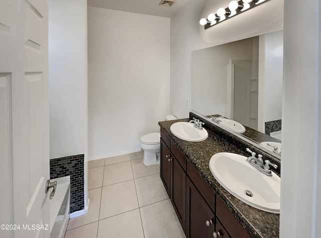 bathroom with vanity, toilet, and tile patterned flooring