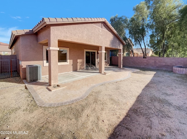 rear view of house featuring a patio area and central AC