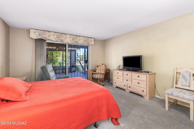 bedroom featuring access to exterior and carpet