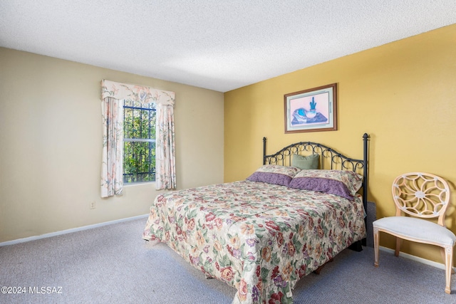 carpeted bedroom featuring a textured ceiling