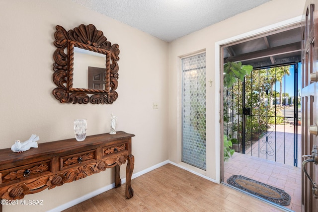 entryway featuring a textured ceiling and light wood-type flooring