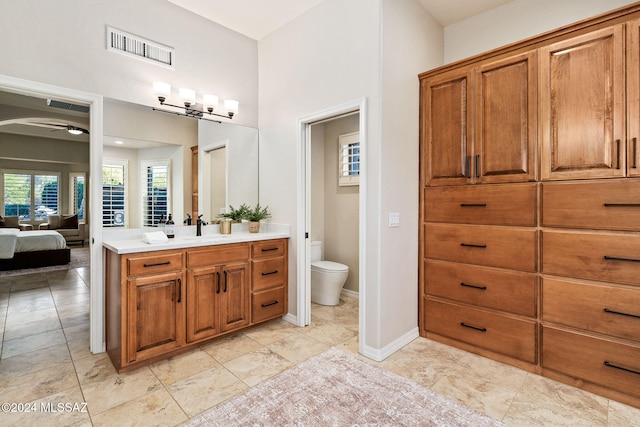 bathroom featuring ceiling fan, vanity, and toilet