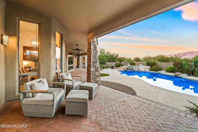 pool at dusk featuring a patio