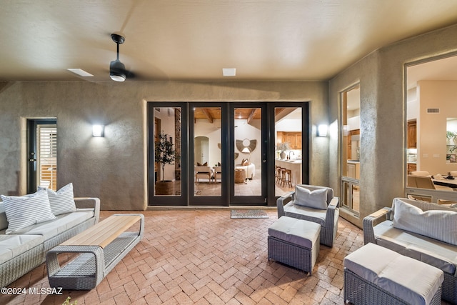 interior space with outdoor lounge area, french doors, and ceiling fan