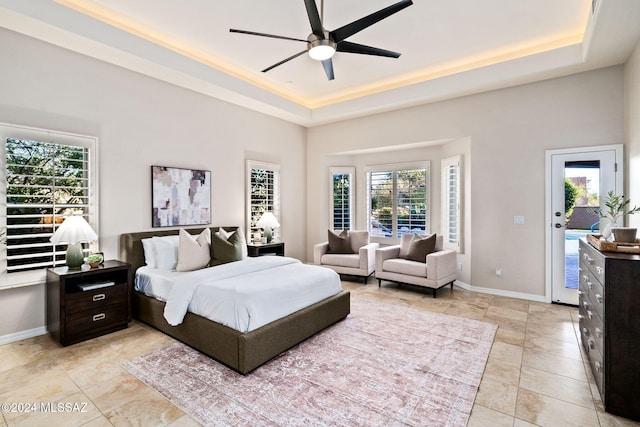 bedroom with access to exterior, multiple windows, and ceiling fan