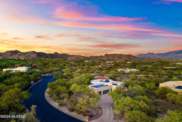 aerial view at dusk featuring a mountain view