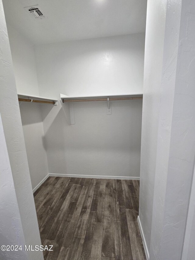 walk in closet featuring wood finished floors and visible vents