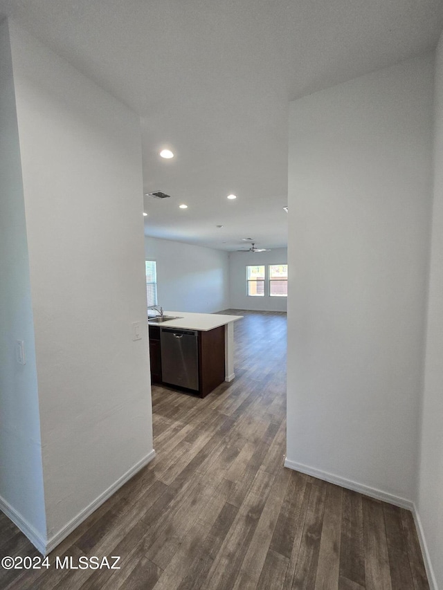 corridor with baseboards, visible vents, wood finished floors, and recessed lighting