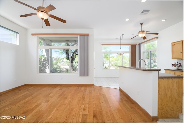 unfurnished living room with visible vents, light wood-style floors, baseboards, recessed lighting, and a ceiling fan