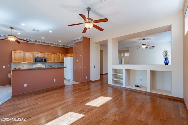 kitchen featuring white appliances, tasteful backsplash, light hardwood / wood-style flooring, and built in shelves