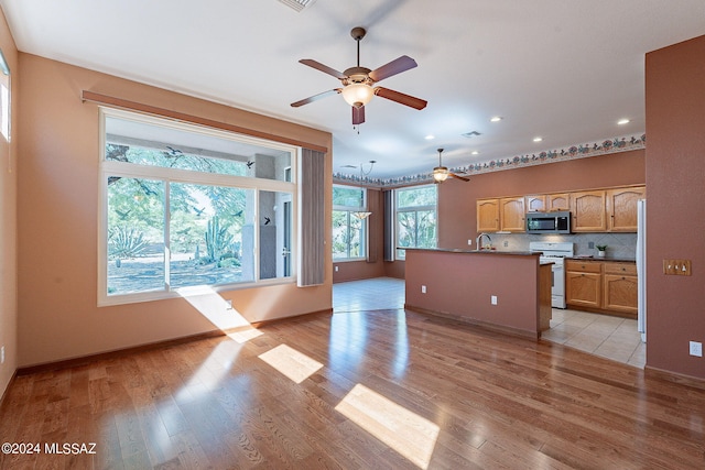 living room featuring recessed lighting, light wood-type flooring, visible vents, and baseboards