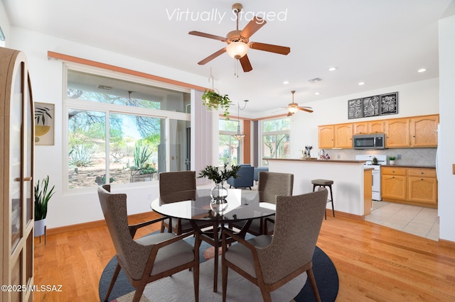 dining room with recessed lighting, a ceiling fan, and light wood-style flooring