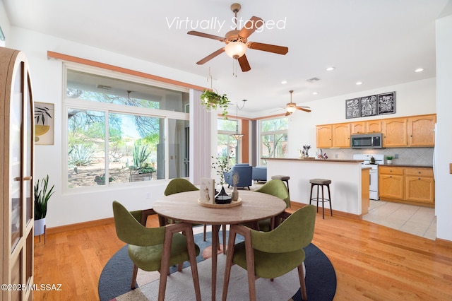 dining room with recessed lighting, baseboards, a ceiling fan, and light wood finished floors