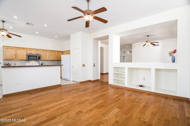 unfurnished living room with visible vents, ceiling fan, light wood-type flooring, recessed lighting, and built in shelves