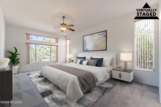 carpeted spare room featuring ceiling fan and plenty of natural light