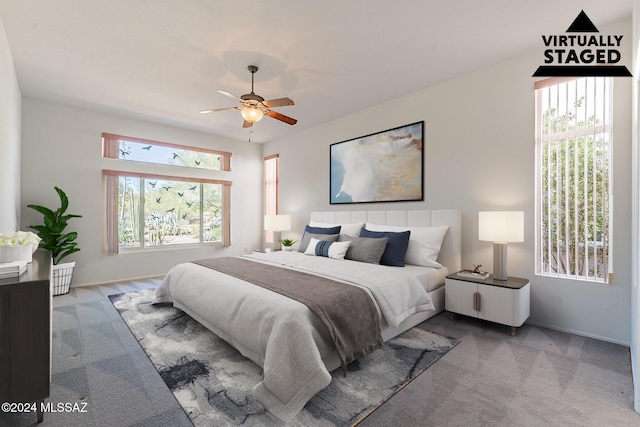 bedroom with ceiling fan, baseboards, and carpet flooring