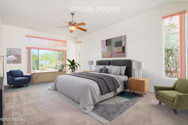 bedroom featuring multiple windows, carpet, and a ceiling fan