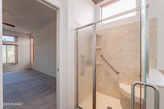 bathroom with ceiling fan and a shower stall