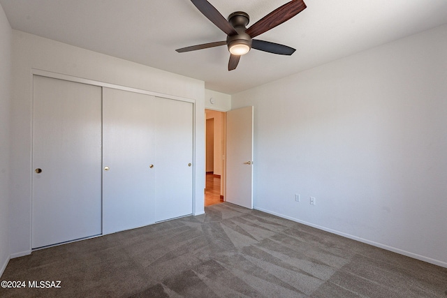 unfurnished bedroom featuring carpet floors, a closet, and a ceiling fan