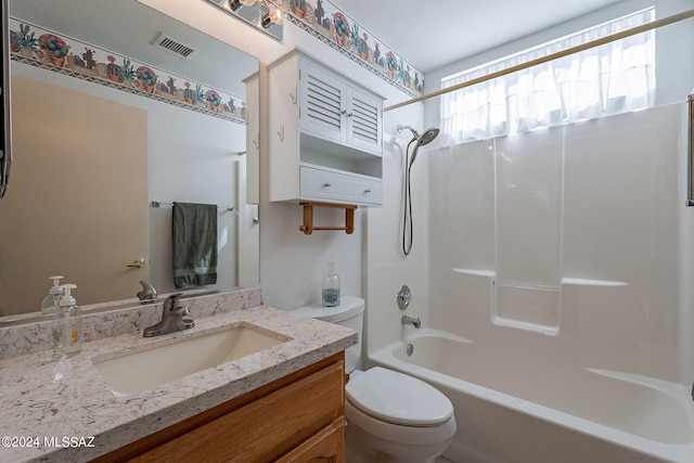 full bathroom featuring toilet, vanity, and tub / shower combination