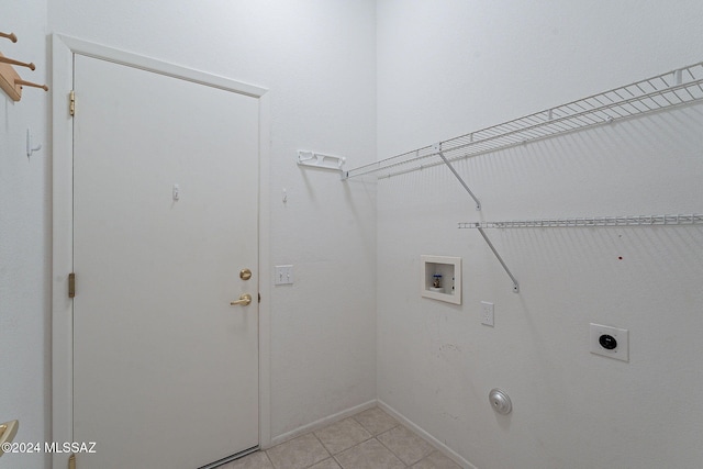 washroom featuring hookup for an electric dryer, gas dryer hookup, washer hookup, and light tile patterned floors