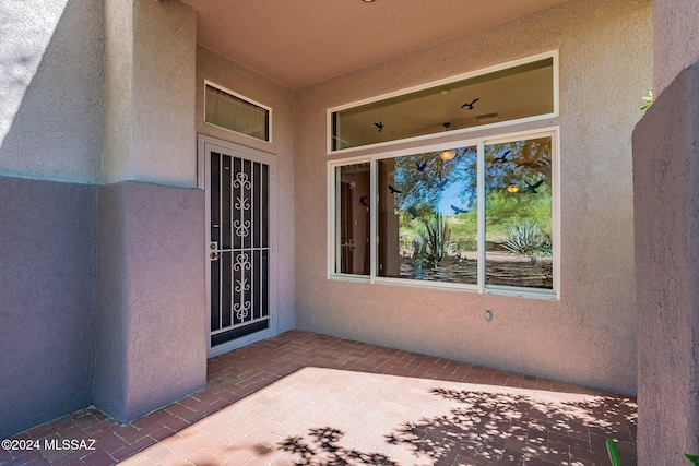 doorway to property featuring a patio