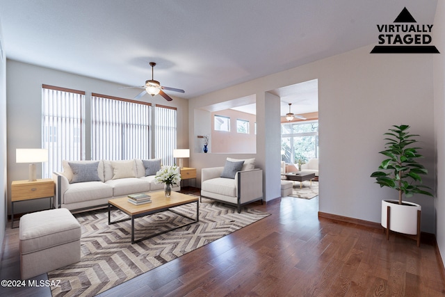 living room featuring dark hardwood / wood-style floors and ceiling fan