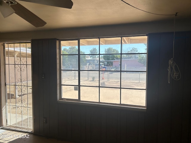 details with wooden walls and ceiling fan