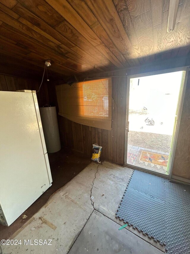 interior space featuring wooden walls and wooden ceiling