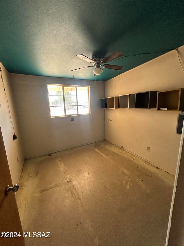 interior space featuring ceiling fan and a textured ceiling