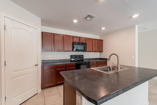 kitchen featuring a center island with sink, black appliances, sink, and light tile patterned floors