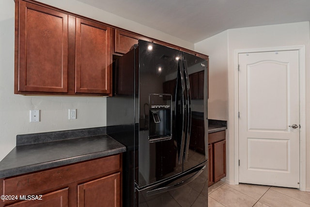 kitchen with light tile patterned floors and black refrigerator with ice dispenser