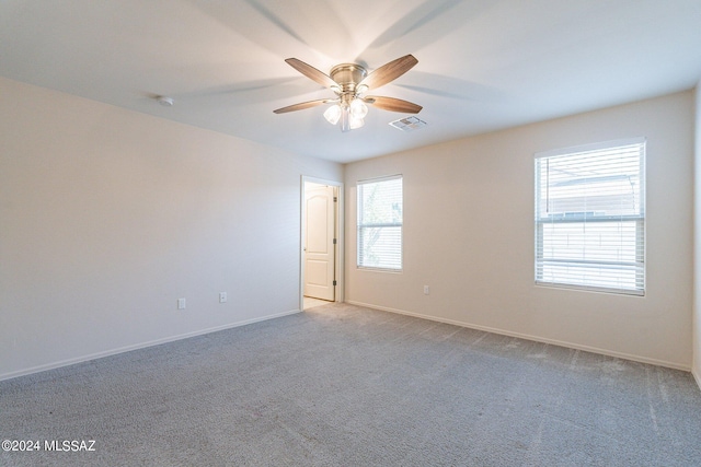 empty room featuring light carpet and ceiling fan