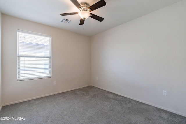 carpeted spare room with ceiling fan