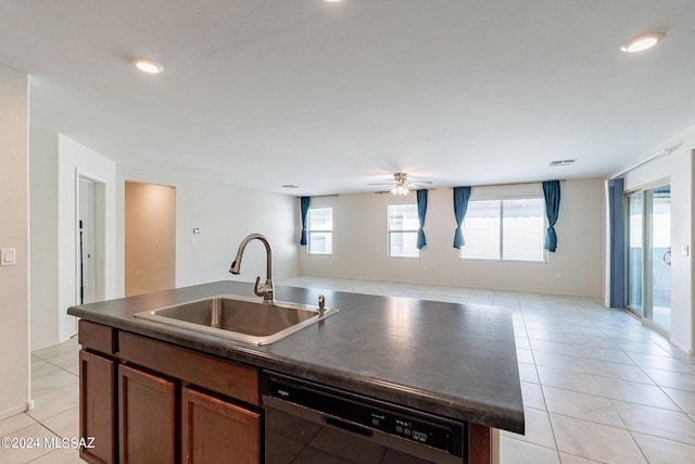 kitchen with light tile patterned flooring, sink, an island with sink, and dishwasher