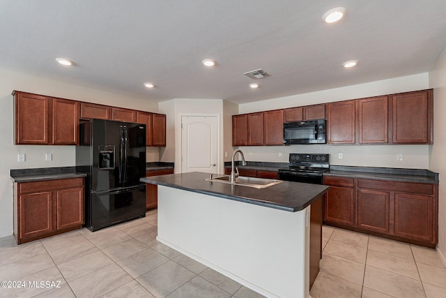 kitchen featuring a center island with sink, sink, black appliances, and light tile patterned floors