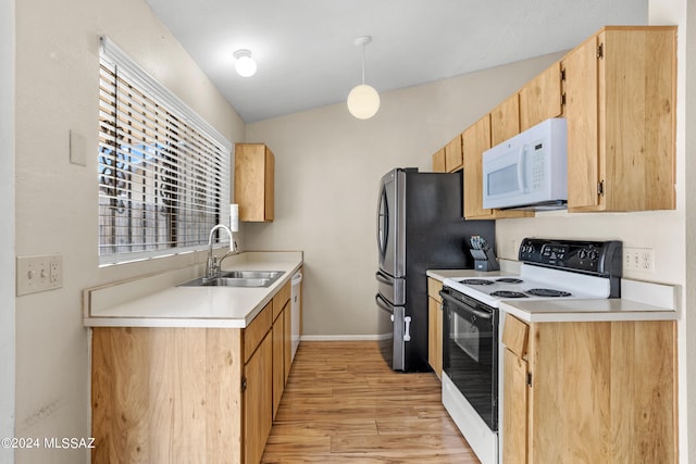 kitchen featuring vaulted ceiling, light hardwood / wood-style flooring, pendant lighting, sink, and white appliances