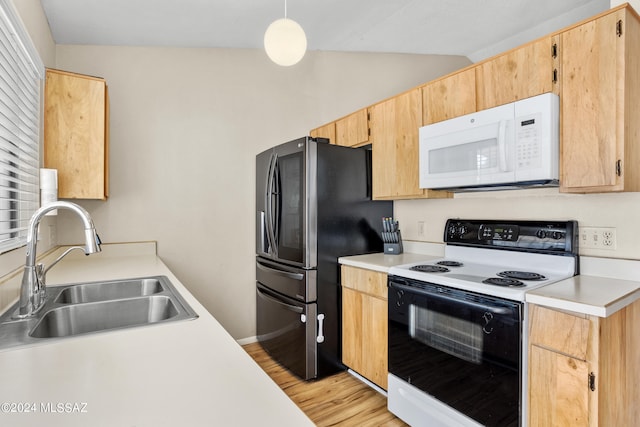 kitchen featuring light hardwood / wood-style flooring, sink, vaulted ceiling, decorative light fixtures, and white appliances