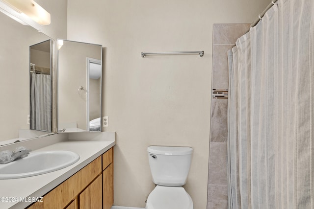 bathroom featuring toilet, a shower with curtain, and vanity