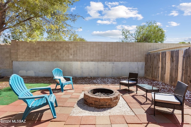 view of patio / terrace featuring an outdoor fire pit