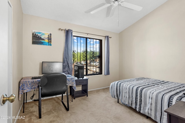 carpeted bedroom featuring ceiling fan and vaulted ceiling