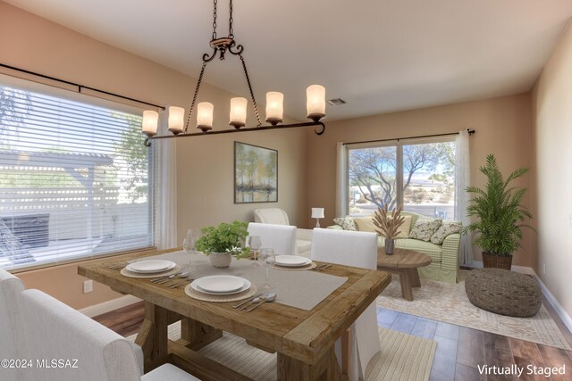 dining room featuring hardwood / wood-style floors and a chandelier