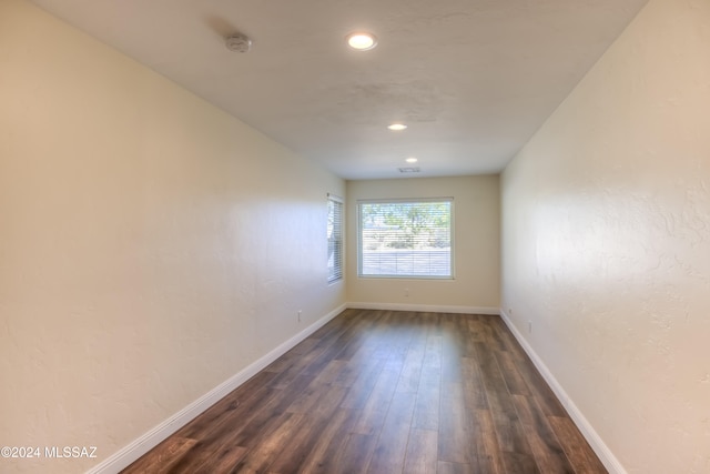 unfurnished room featuring dark hardwood / wood-style flooring