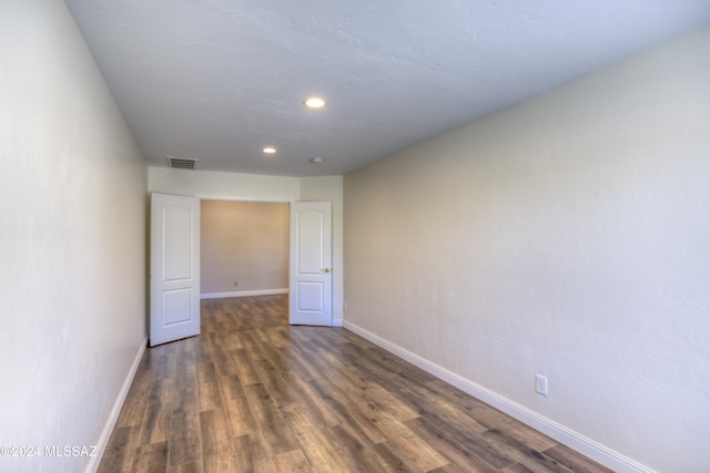 empty room featuring dark hardwood / wood-style flooring