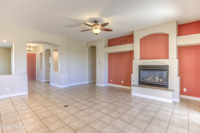 unfurnished living room with light tile patterned flooring and ceiling fan