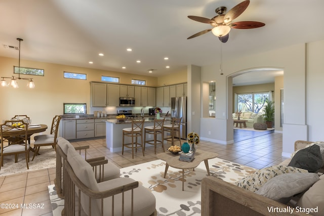 tiled living room with sink and ceiling fan