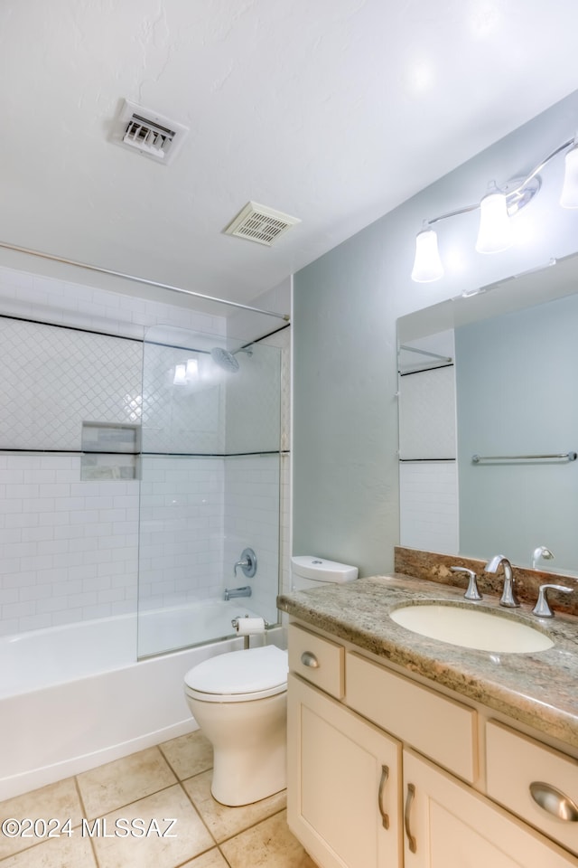 full bathroom with vanity, tiled shower / bath combo, toilet, and tile patterned flooring